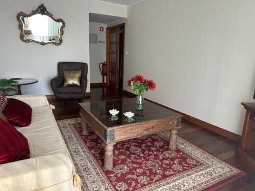 a living room with a couch and a coffee table at Azor International Apartment II in Ponta Delgada