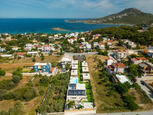an aerial view of a small town next to the ocean at Modular Bungalows With Heated Pool Artemis Greece in Artemida