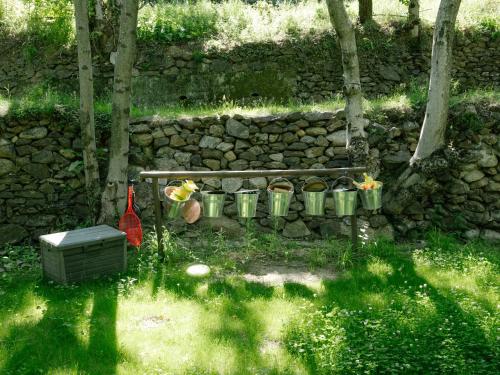 a stone wall with a bench and some plants at Casa Bauxells in Sahorre