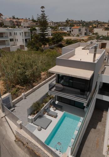 an aerial view of a house with a swimming pool at Athos Guesthouse in Stalos