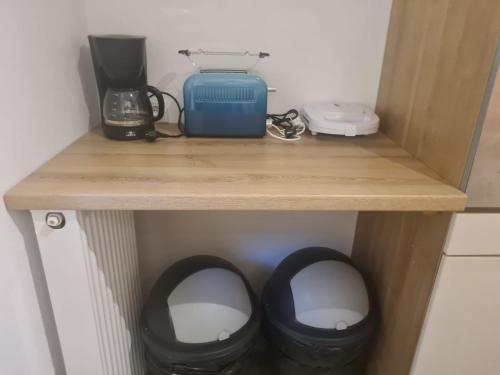 a wooden shelf with two black trash cans on it at Modernes Work and Stay Apartment Nähe Attendorn und Plettenberg für 5 Personen in Plettenberg