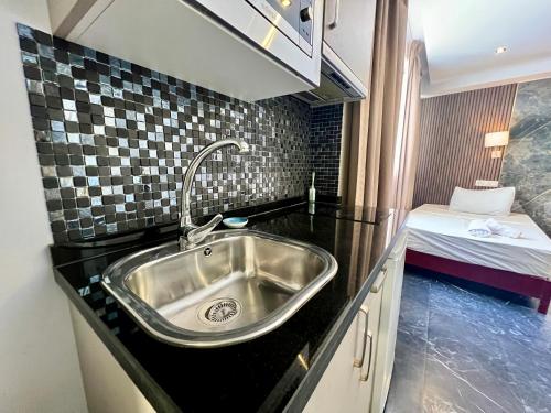 a kitchen with a sink and a bed in a room at Costa Marbella Star Light in Marbella