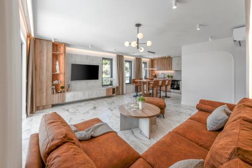 a living room with a couch and a table at Azzurea Residence in Zaton