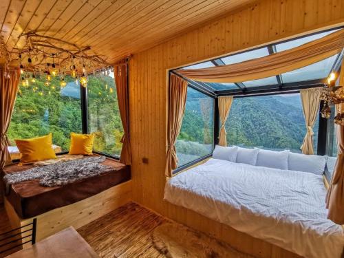 a room with a bed and a large window at Eco House Merisi in Merisi