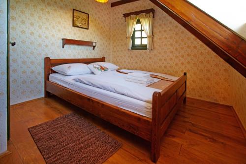 a wooden bed in a room with a staircase at Apartments Zaboky Village in Zabok