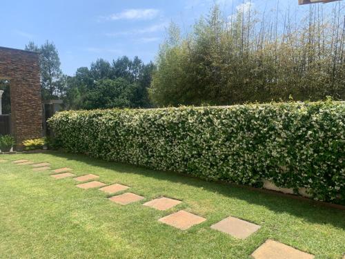 une haie avec des pas japonais dans une cour dans l'établissement La Villa Des Trois Pins, à Andernos-les-Bains