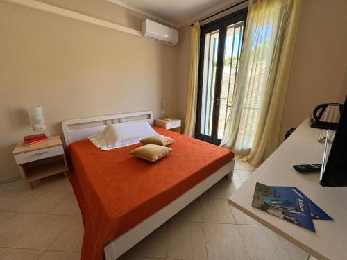 a bedroom with a bed with two pillows on it at Calascoglietti in Stintino