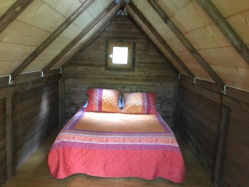 a bed in a small room in a attic at La fricassée in Aigues-Mortes