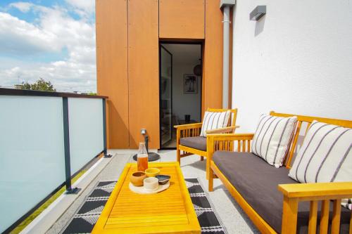 un patio avec deux chaises et une table sur un balcon dans l'établissement -SHELBY- T2 Arriere corniche parking et terrasse, à Concarneau