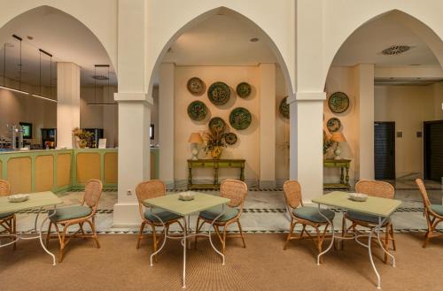 a restaurant with tables and chairs and plates on the wall at Impressive Playa Granada Golf in Motril