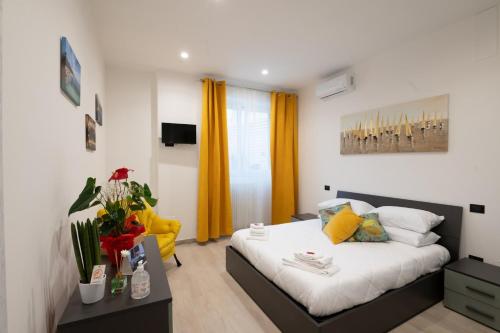 a bedroom with a bed and a yellow curtain at Da Zia Gina Locazione Turistica in Bisceglie
