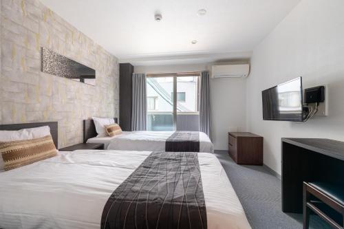 Postel nebo postele na pokoji v ubytování Komachi Hotel Nipponbashi