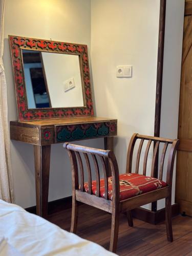 a mirror sitting on top of a table with two chairs at Saint Johns Hill Boutique Ephesus in Selcuk