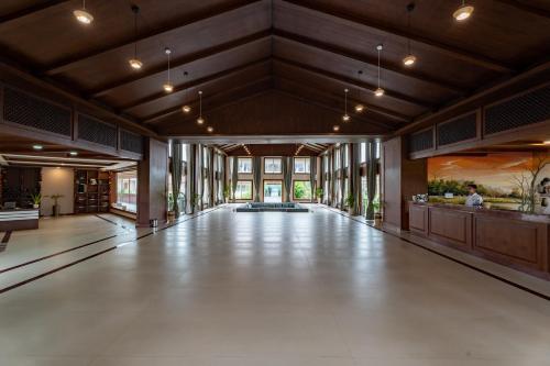 an empty lobby with a large hall with a painting at River Bank Jungle Resort, Chitwan in Bharatpur