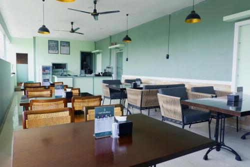 a dining room with tables and chairs at LEAF HoteL in Jakarta