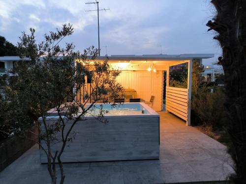 a backyard with a swimming pool and a house at Jesolo Beach Villa in Lido di Jesolo