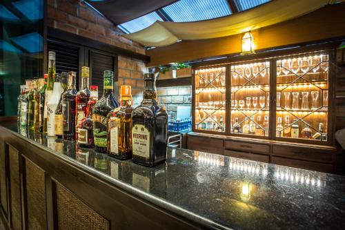 a bar with bottles of alcohol on a counter at Chankam Boutique Hotel in Chiang Mai