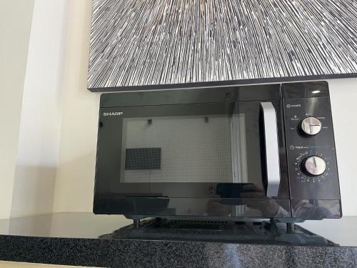 a microwave oven sitting on top of a counter at 5 Bedroom Holiday Villa - Kuta Regency B8 in Kuta