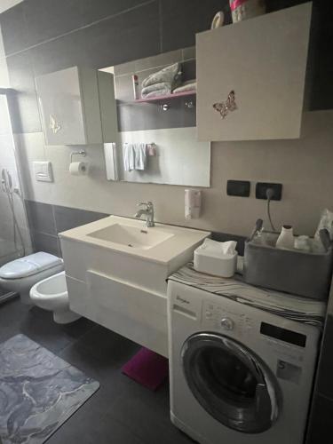 a bathroom with a washing machine and a sink at Lady Hana in Marghera