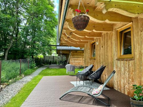a group of chairs sitting on a porch of a house at Domki u Magdy in Zakopane