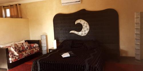 a bedroom with a bed with a carved number on the wall at Maison d'Hôtes à Marrakech in Marrakech