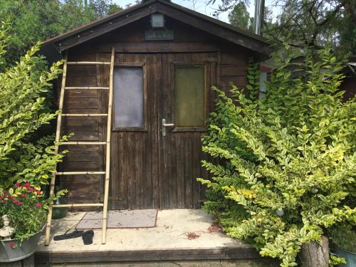a wooden out house with a ladder in front of it at La fricassée in Aigues-Mortes