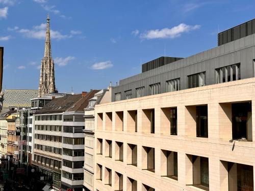a view of a building with a tower in the background at Aviano Boutique Hotel in Vienna
