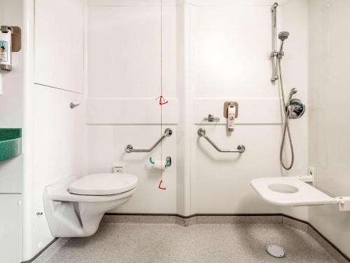 a bathroom with a toilet and a shower and a sink at ibis Hull City Centre in Hull