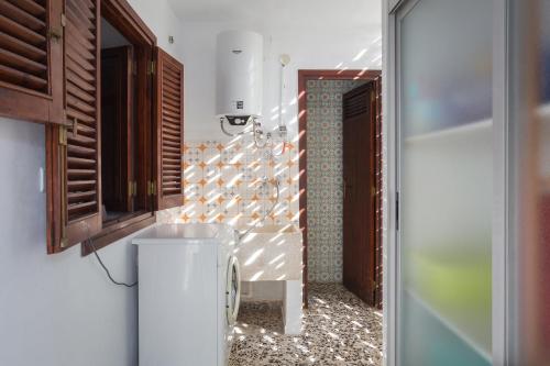a bathroom with a toilet and a wall at Llúria 51 in Oliva