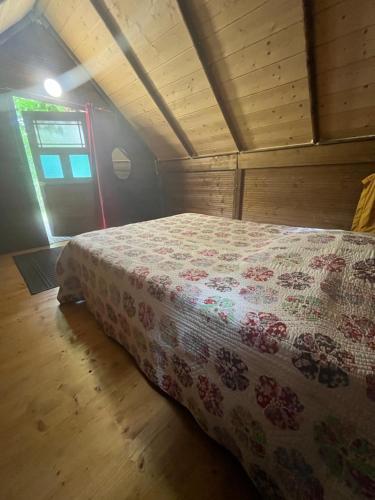 a bedroom with a bed in a wooden room at La fricassée in Aigues-Mortes
