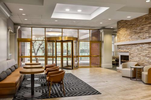 a lobby with a fireplace and a group of stools at Homewood Suites by Hilton Washington, D.C. Downtown in Washington