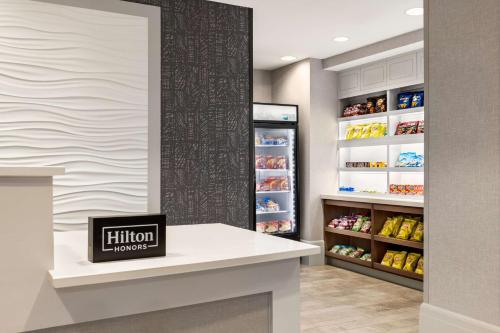 a kitchen with an open refrigerator in a store at Homewood Suites by Hilton Washington, D.C. Downtown in Washington