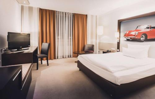a hotel room with a bed and a car on the wall at elaya hotel stuttgart ludwigsburg ehemals Abacco by Rilano in Korntal-Münchingen