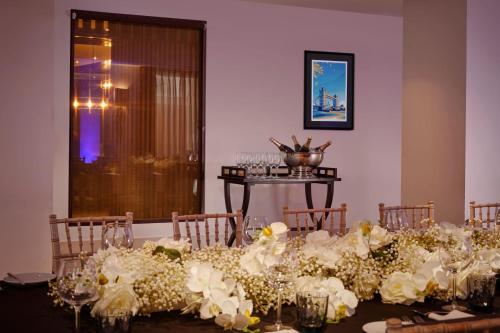 a table with a bunch of white flowers on it at Sheraton Heathrow Hotel in Hillingdon