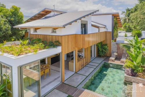 an aerial view of a house with a swimming pool at Villa Mango Beach, face au lagon de l'Ermitage in La Saline les Bains