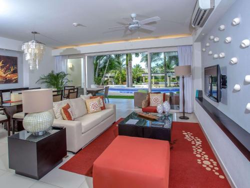 a living room with a white couch and a red rug at Marival Distinct All-Suites & World Spa - Handwritten Collection in Nuevo Vallarta 
