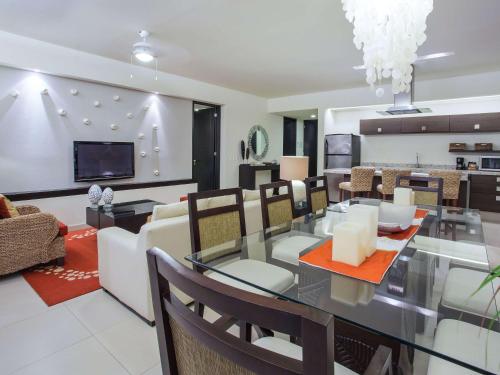 a dining room and living room with a table and chairs at Marival Distinct All-Suites & World Spa - Handwritten Collection in Nuevo Vallarta 