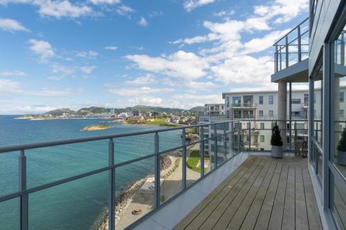 an apartment balcony with a view of the ocean at Eksklusiv toppleilighet med det lille ekstra. in Bodø