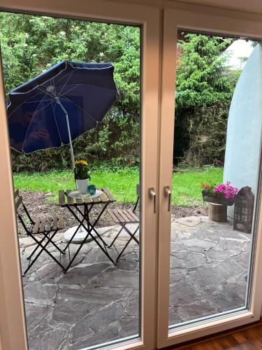 a patio with an umbrella and a table and a chair at Der Erberbauer in Piding