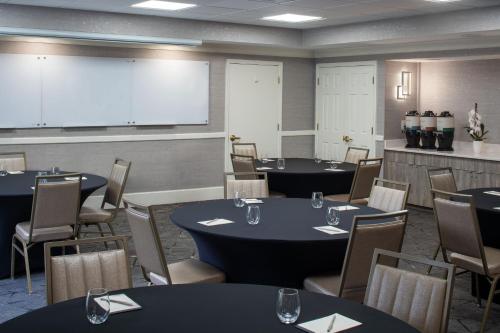 a conference room with tables and chairs and a screen at Residence Inn Orlando Convention Center in Orlando