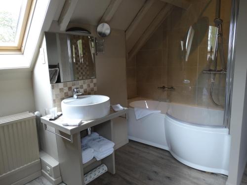 a bathroom with a sink and a shower and a tub at B&B Castel 't Haantje in Ruiselede