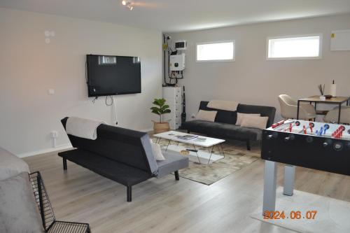 a living room with a couch and a flat screen tv at Villa Simonsson in Nykvarn