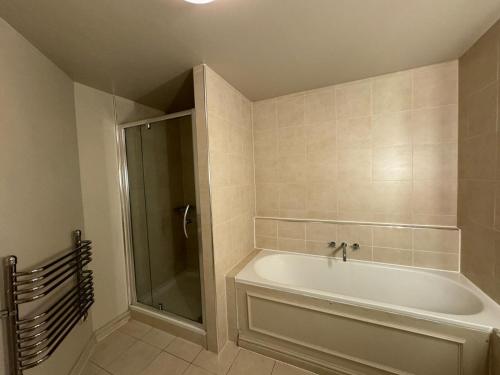a bathroom with a white tub and a shower at Harte and Garter Hotel in Windsor