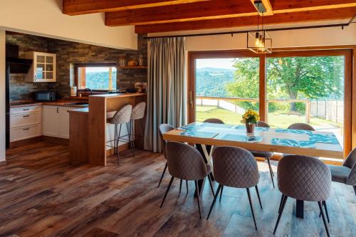 a kitchen and dining room with a table and chairs at Kasztanowe Zacisze in Jaworzynka