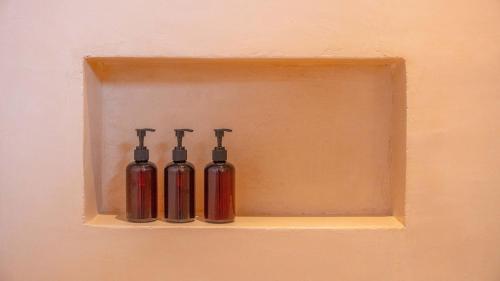 three fire hydrants sitting on a shelf in a wall at La Alberca Hotel Boutique in Mazunte