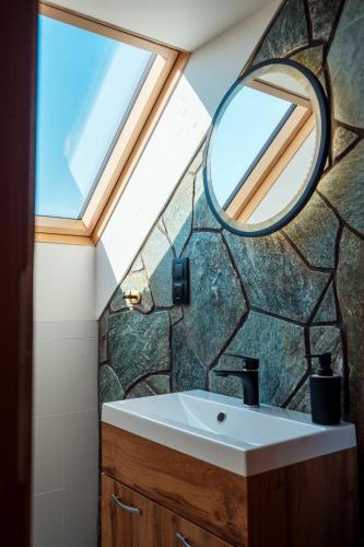 a bathroom with a sink and a mirror at Kasztanowe Zacisze in Jaworzynka