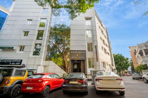 a group of cars parked in front of a building at Hotel Classio Koramagala in Bengaluru