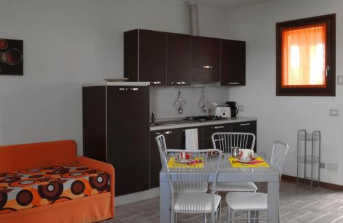 a kitchen with a table and a dining room at Residenza Principina in Principina Terra