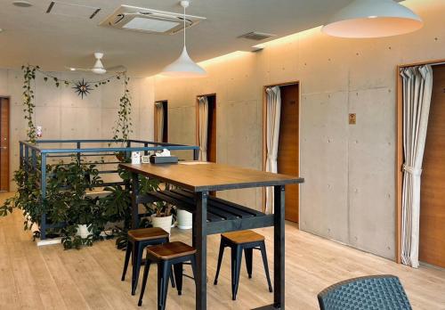 an office with a table and some chairs and a plant at HOSTEL SunTerrace Ishigaki in Ishigaki Island