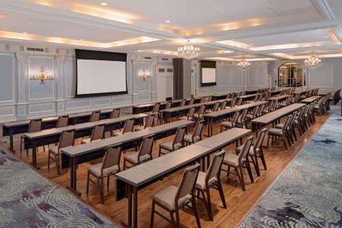 a conference room with tables and chairs and a screen at The Westin Governor Morris, Morristown in Morristown